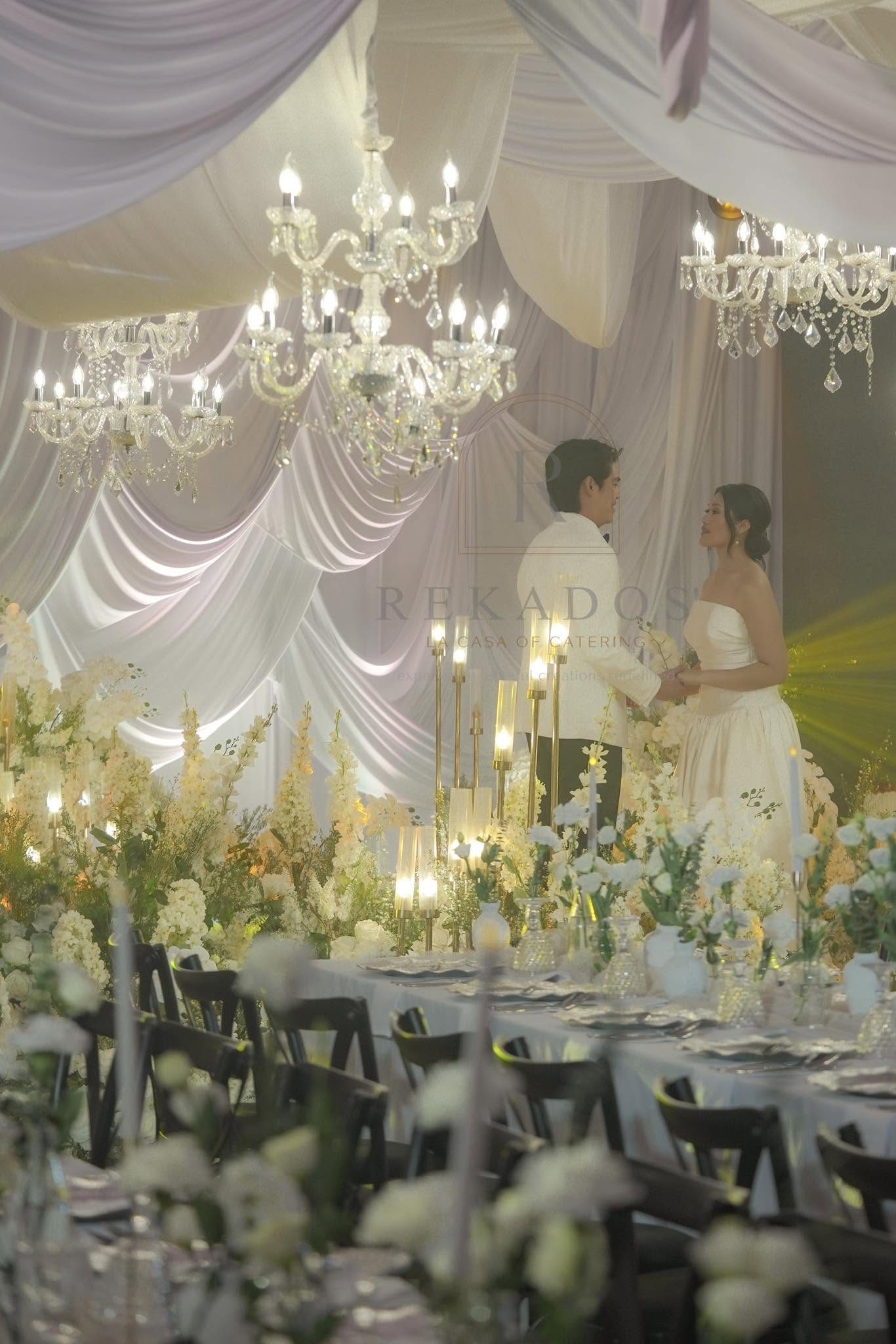 Couple at a chandelier reception